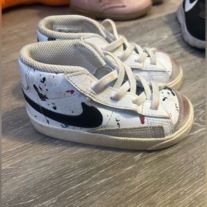 White paint splattered Nikes